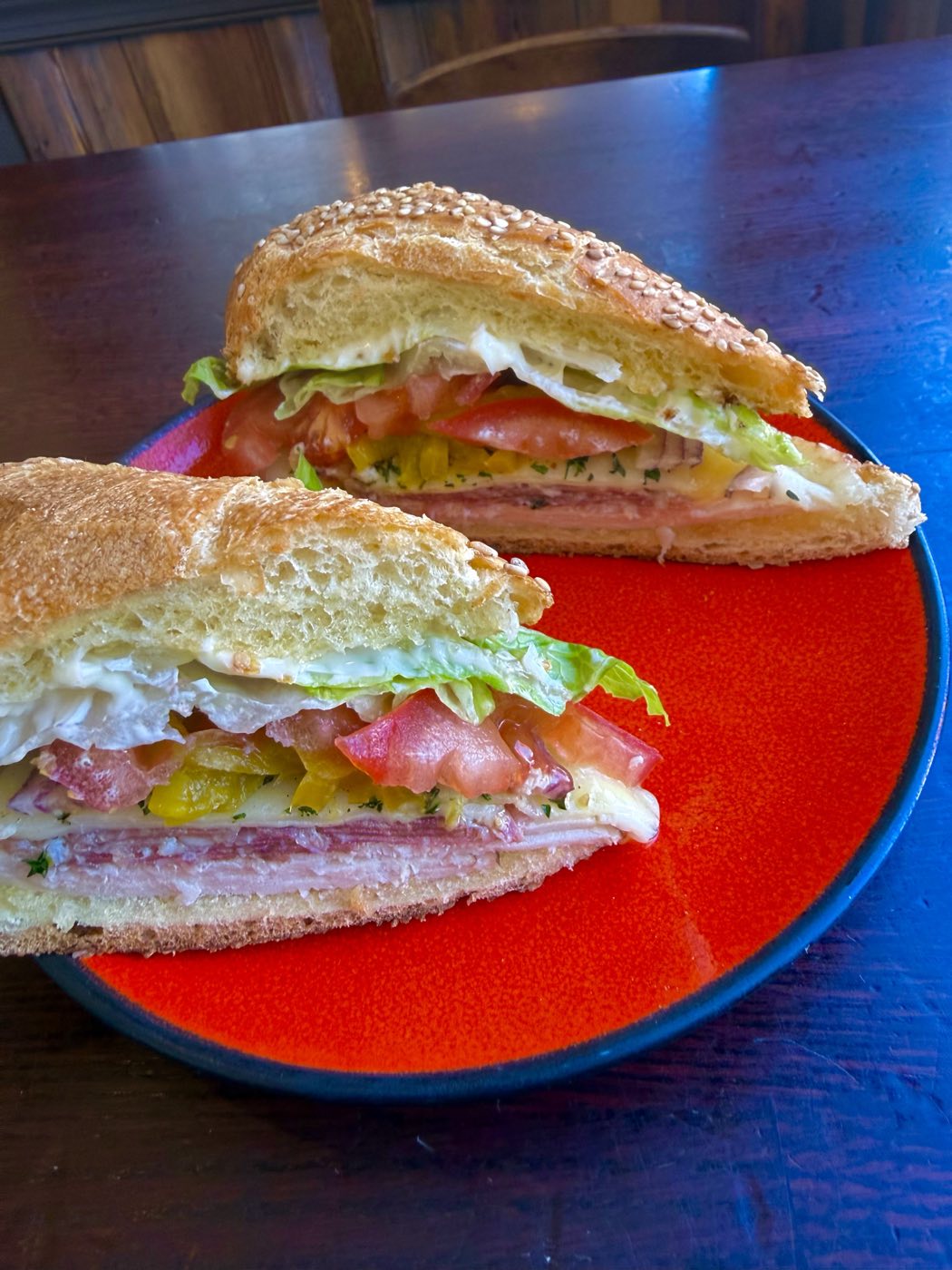 Italian sub with salami, ham, provolone, tomato and lettuce on a sesame roll at Tino's Tazza