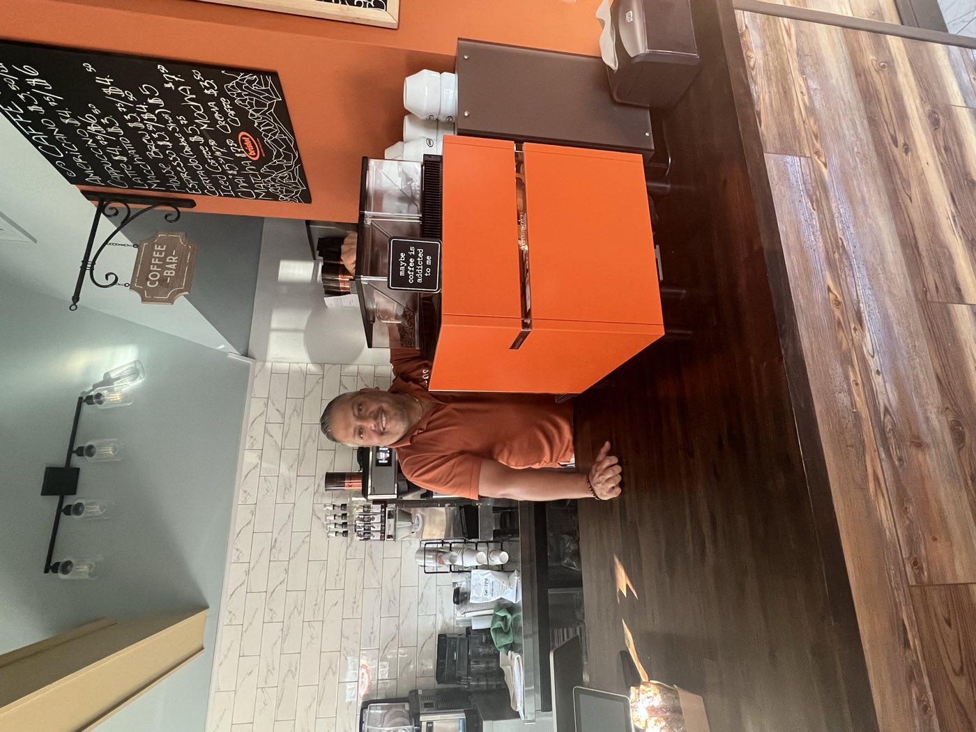 Behind the coffee bar at Tino's Tazza in Kingston, NJ, with the espresso machine and chalkboard menu