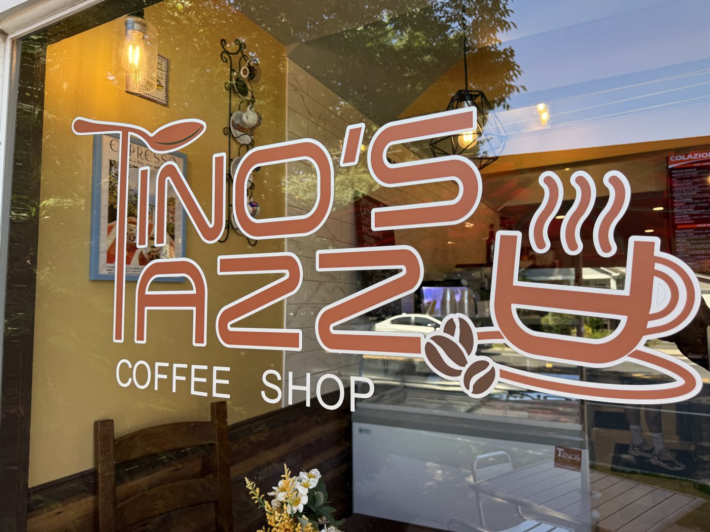 The Tino's Tazza Coffee Shop logo on the storefront window in Kingston, NJ